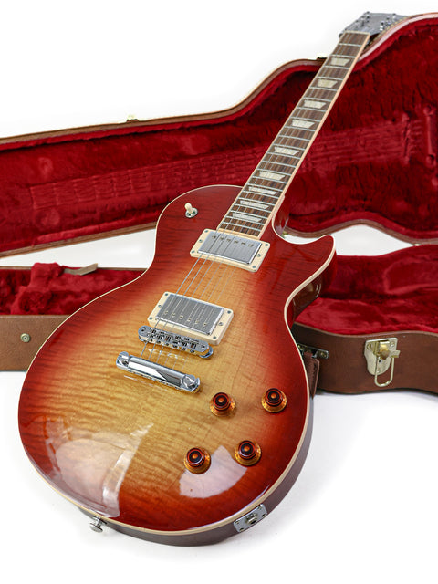A red case containing a 2018 Gibson Les Paul Standard guitar, emphasizing its classic style and premium build.