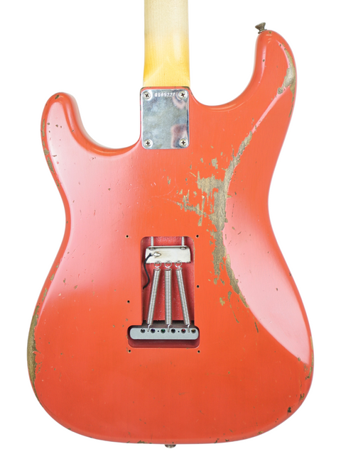 A red guitar with a yellow body and neck, showcasing the Fender Kyle McMillin Masterbuilt 1960 Stratocaster Relic from 2020.
