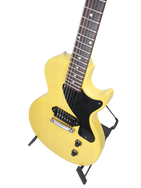 A striking yellow electric guitar, the Gibson Custom Les Paul Jr. TV Yellow, elegantly resting on a stand.