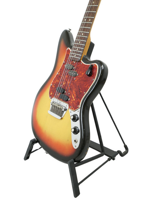 A stunning sunburst Fender Electric XII guitar from 1965, proudly positioned on a stand, ready to play.
