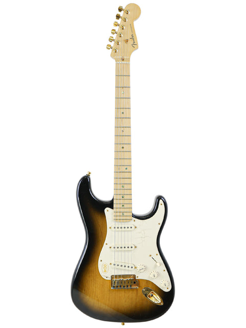 A sunburst electric guitar with a white pickguard and maple neck on a white background.