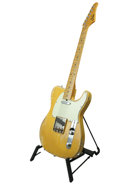 A vibrant yellow guitar on a stand, featuring a white background for a striking contrast.