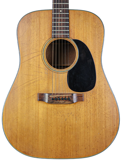 A vintage 1955 Martin D-28 acoustic guitar, showcasing its classic design and rich wood finish.