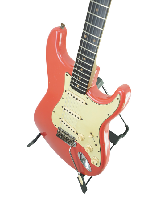 A vintage 1963 Fender Stratocaster in Fiesta Red, featuring a white pick guard, previously owned by Phil Emmanuel.