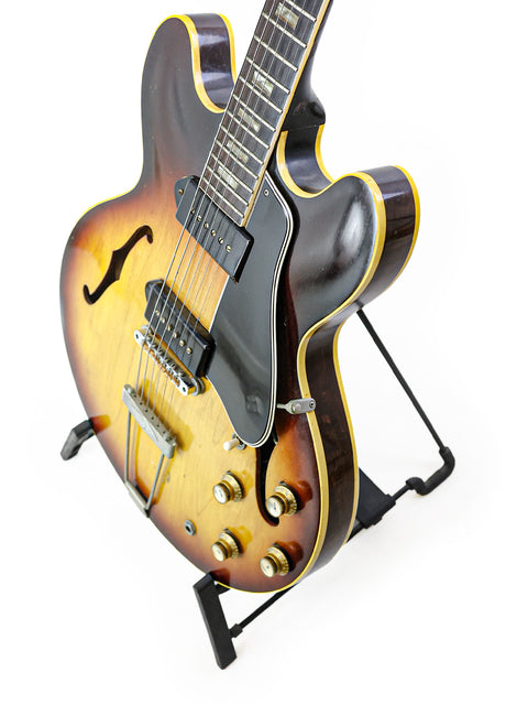 A vintage 1964 Gibson ES-330TD guitar showcased on a stand, capturing the essence of classic American craftsmanship.