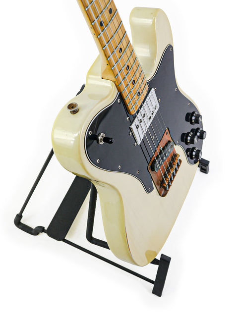 A vintage 1978 white Fender Telecaster Custom electric guitar resting on a black stand.
