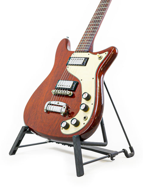 A vintage Epiphone Wilshire guitar from 1966 on a stand, showcased with a plain white background.
