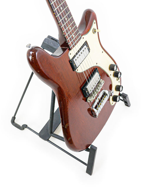A vintage Epiphone Wilshire guitar from 1966 on a stand, showcased with a white background.