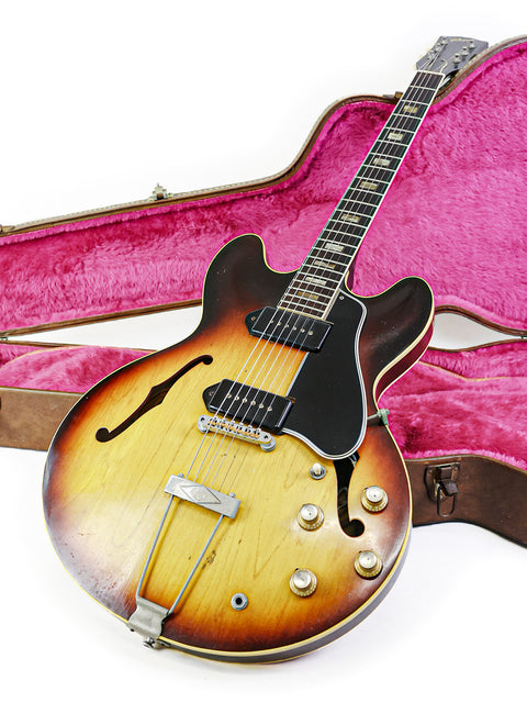 A vintage Gibson ES-330TD guitar from 1964, securely placed in its case, representing a piece of musical history.