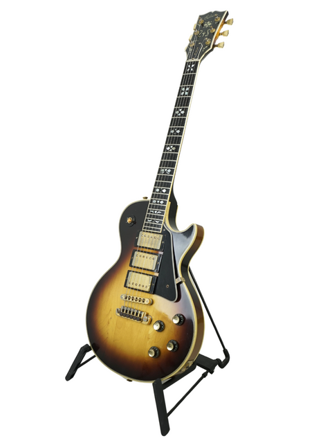 A vintage Gibson Les Paul Artisan guitar from 1978 resting on a stand, emphasizing its classic craftsmanship.
