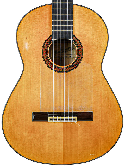  A vintage José Ramírez 2A classical guitar with a rich wooden body and neck, crafted in Spain in 1963.
