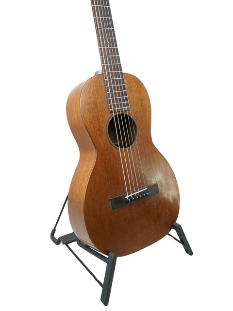 A vintage Martin 2-17 Flat Top acoustic guitar from 1928, beautifully showcased on a stand, emphasizing its historical significance.