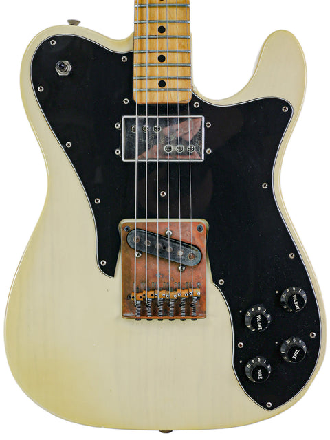 A white Fender Telecaster Custom electric guitar from 1978 featuring a black pickup, showcasing classic design and craftsmanship.