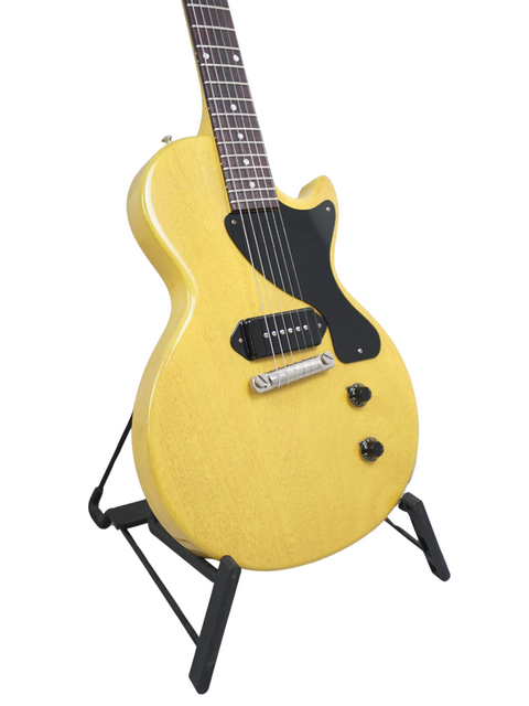 A yellow electric guitar, the Gibson Custom Les Paul Jr. TV Yellow, proudly positioned on a stand for all to admire.
