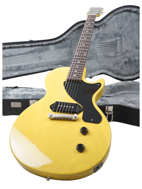 A yellow electric guitar, the Gibson Custom Les Paul Jr., securely placed in its case, perfect for music lovers.
