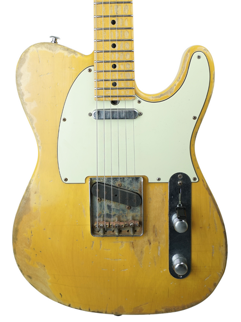 A yellow guitar with a white pickguard, showcasing the Suhr Classic T Antique Trans Butterscotch from 2015.