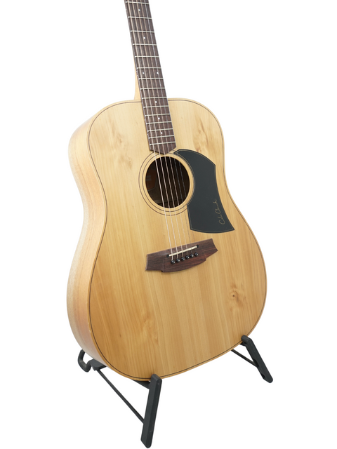 Acoustic guitar on a stand against a white background.