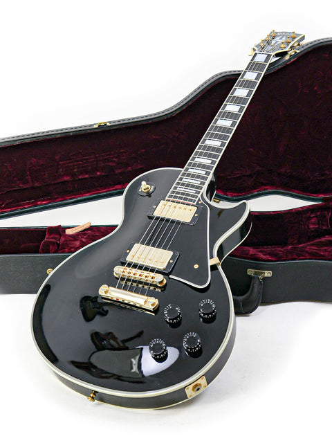 Black Gibson Les Paul Custom electric guitar in a case, showcasing its sleek design and craftsmanship from the USA, 2010.