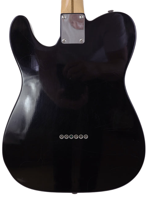 Black Telecaster Thinline guitar with wooden body and black pickguard, a classic model from Fender Custom Shop, 2005.