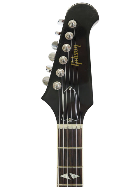 Black guitar with a white headstock, showcasing the Gibson Custom Shop Trini Lopez model from the USA, 2009.
