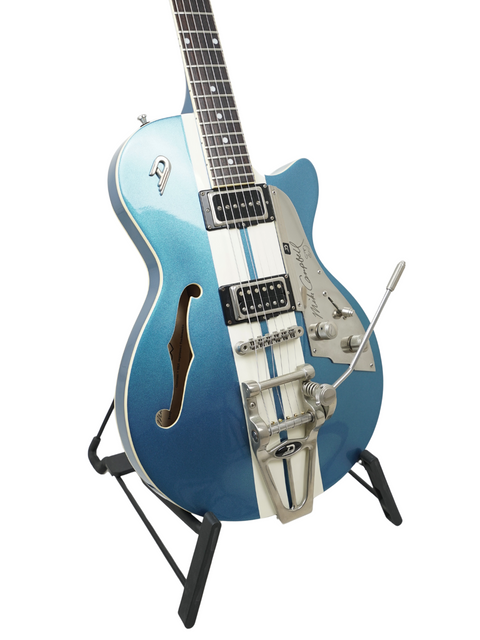 Blue electric guitar with a whammy bar and dual pickups, on a stand, isolated on white.