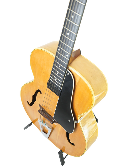 Classic 1940 Vintage Vega C-66 guitar with a wooden body and stylish black pick guard, ideal for strumming tunes.