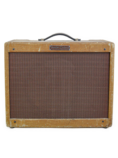 Classic 1959 Fender Tweed Deluxe 5E3 amplifier with a distinctive brown and black finish, embodying vintage charm.