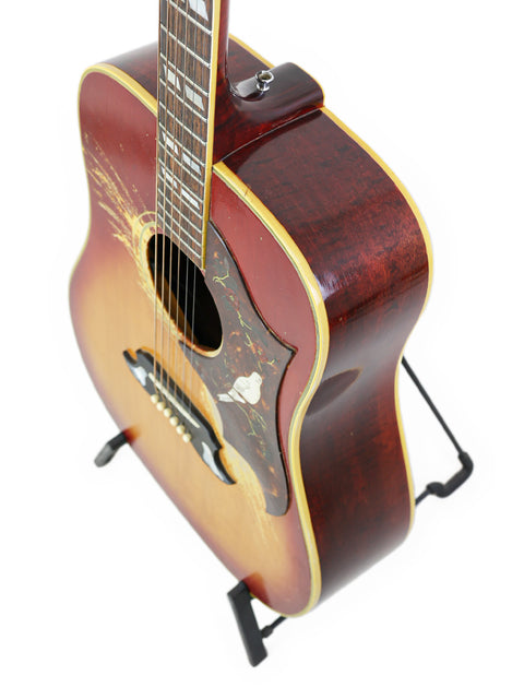 Classic 1968 Gibson Dove guitar in red and black, embodying vintage charm and exceptional craftsmanship.