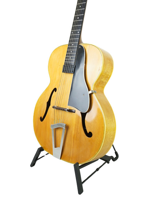 Classic Vega C-66 guitar from 1940 resting on a stand, highlighted by a simple white background.