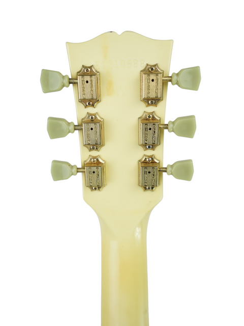 Close-up image of the headstock of a 1989 Gibson Les Paul Standard, featuring a striking Arctic White finish.