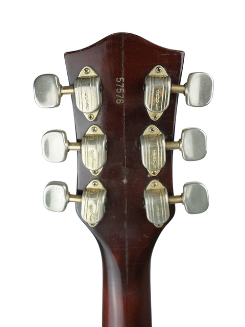 Close-up of a 1967 Gretsch 6122 headstock, highlighting four knobs that exemplify its vintage charm and quality.