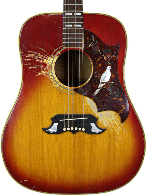 Close-up of a 1968 Gibson Dove acoustic guitar featuring a bird illustration on the back, highlighting its vintage appeal.