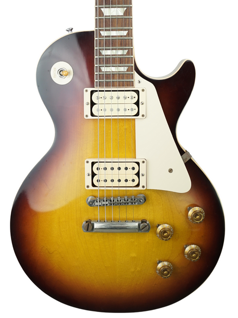 Close-up of a Gibson Custom LPR-8 '58 Les Paul Standard R/I electric guitar featuring a vibrant sunburst finish.