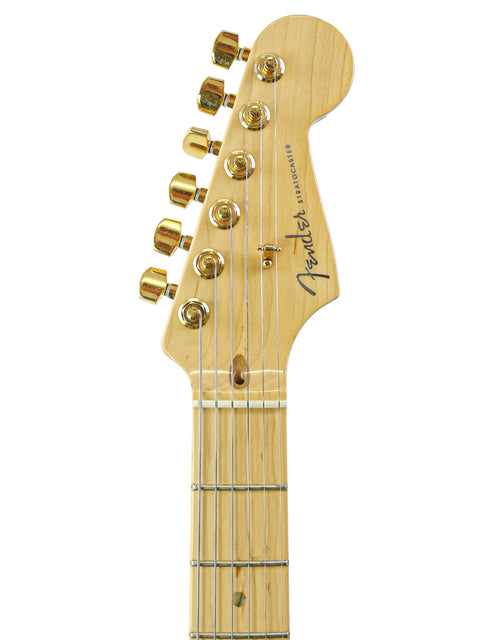 Close-up of electric guitar headstock with tuning pegs and part of the neck.