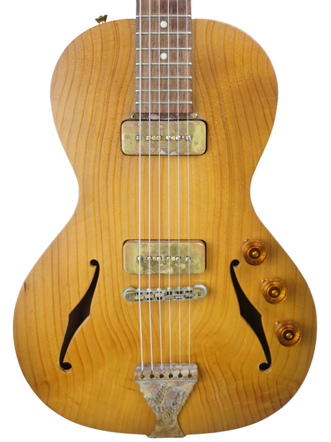 Close-up of the B&G 'Little Sister' guitar body, highlighting f-holes, pickups, and its natural wood grain.