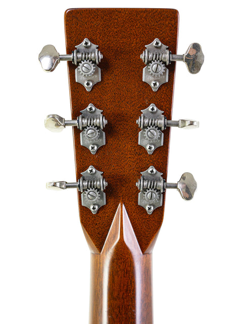 Close-up of the headstock on a Martin Sting acoustic guitar, showcasing four knobs, signed by Sting, limited edition 2005.