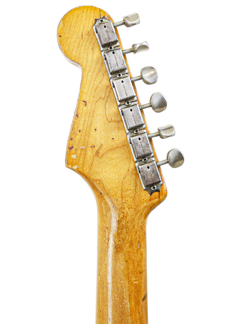 Close-up shot of the neck from a 1963 Fender L-Series Stratocaster, revealing its classic vintage style and details.
