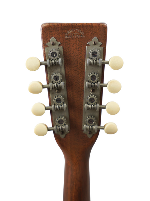 Detailed view of a 1924 Martin AK Mandolin headstock, showcasing four knobs for tuning and vintage craftsmanship.