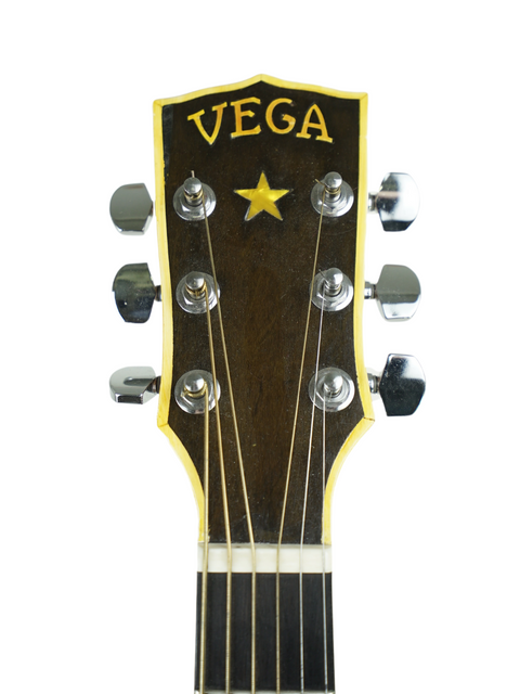 Detailed view of a 1940 Vega C-66 guitar headstock featuring the classic "Vega" branding.
