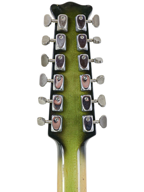 Detailed view of a 1964 Burns Double Six 12-string guitar headstock, featuring a striking green and black color scheme.