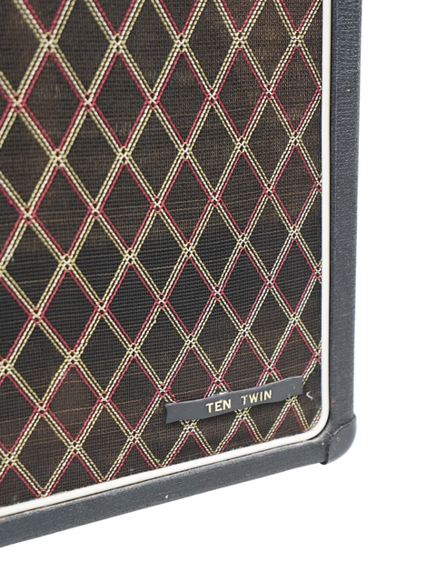 Detailed view of a 1964 Vox AC10 Twin guitar amp showcasing its unique black and red design.