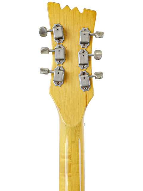 Detailed view of a 1967 Mosrite Celebrity III guitar headstock with four knobs, showcasing its vintage charm.