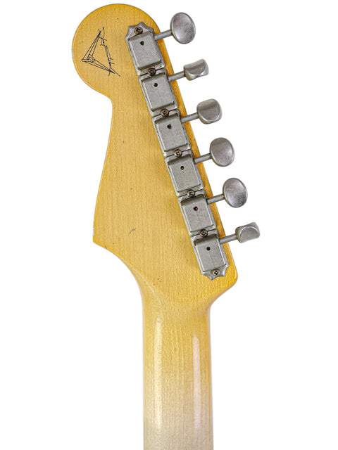 Detailed view of a Fender Yuriy Shishkov Master Built ‘59 Stratocaster Relic guitar head on a white backdrop.