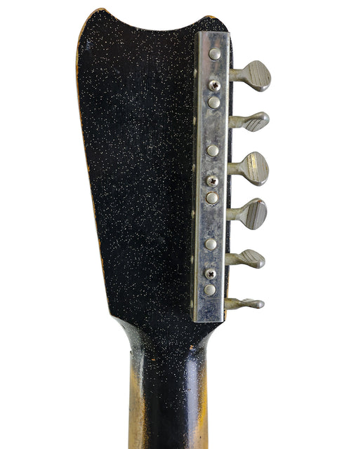 Detailed view of a mid-1960s Harmony Silvertone 1448 guitar head, showcasing its elegant black headstock design.