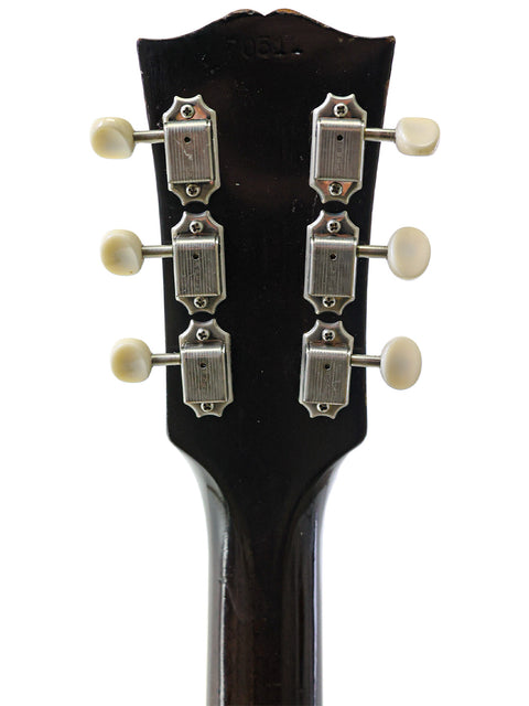 Detailed view of the headstock from a 1964 Gibson ES-330TD electric guitar, highlighting its vintage charm and features.