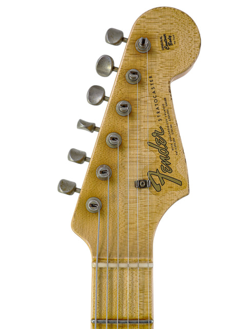 Detailed view of the headstock from a Fender John Cruz Master Built ‘64 Stratocaster Relic, featuring a rich wooden body.