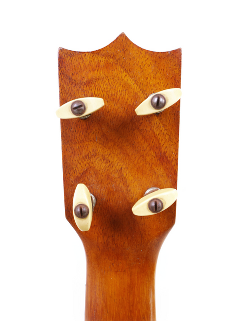 Detailed view of the headstock of a 1928 vintage Kamaka Pineapple Style #3 ukulele, highlighting its craftsmanship.