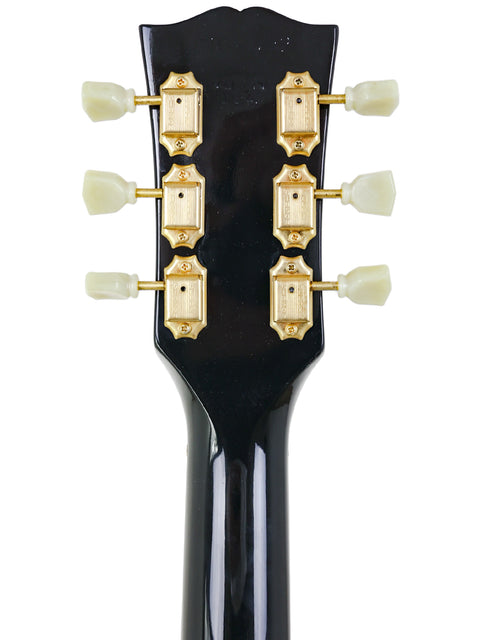 Detailed view of the headstock on a 1999 USA Gibson Nighthawk electric guitar, highlighting its quality and unique features.
