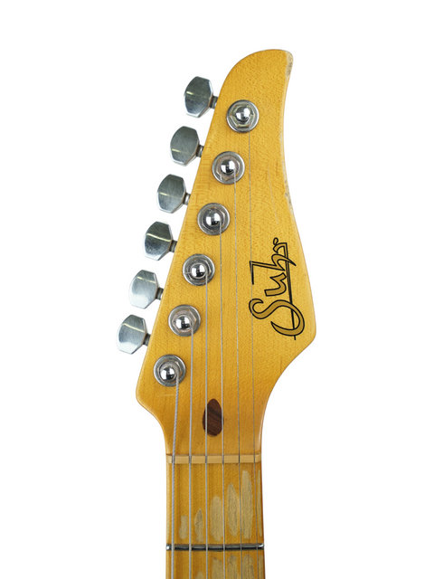 Detailed view of the headstock on a 2015 Suhr Classic T, featuring a vintage butterscotch color and aged look.