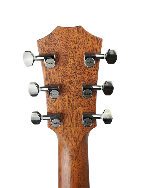Detailed view of the neck of a Taylor GT 811e acoustic guitar from 2022, highlighting four tuning knobs.